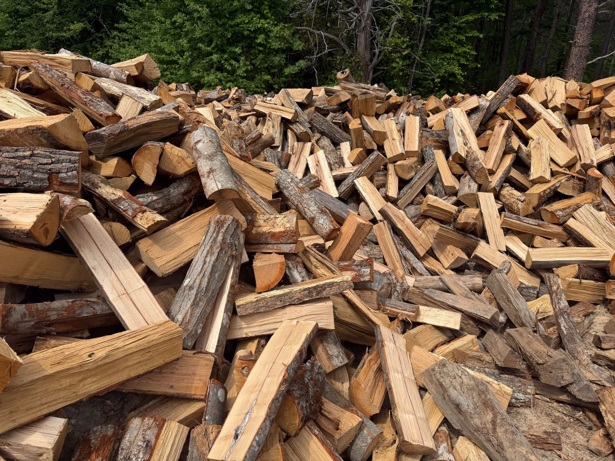 Massive pile of split firewood — Crossroads Firewood Co. bulk inventory