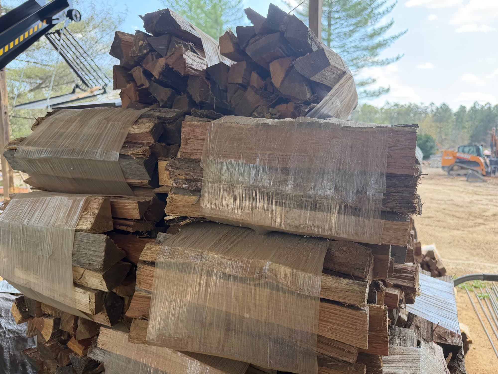 Stacked plastic-wrapped firewood bundles — Crossroads Firewood Co.